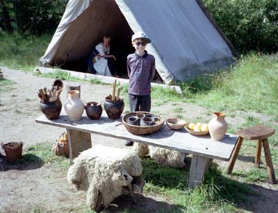 Martin stands behind a table covered with Viking pots