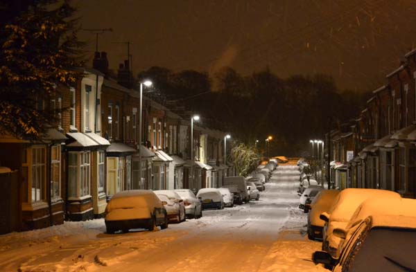 Snow-covered Kitchener Road at night
