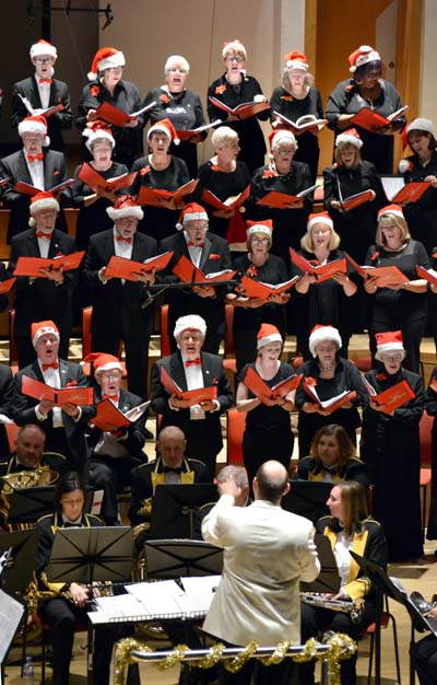 The choir wearing Santa hats
