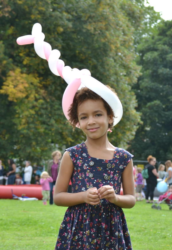 Wearing a hat made from a balloon