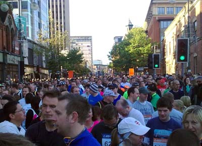 A crowd of runners in a city street