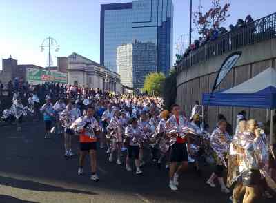 Runners wrapped in foil move off Broad Street