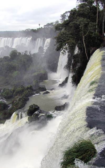 Water flows over a nearby fall, while more falls stretch into the distance