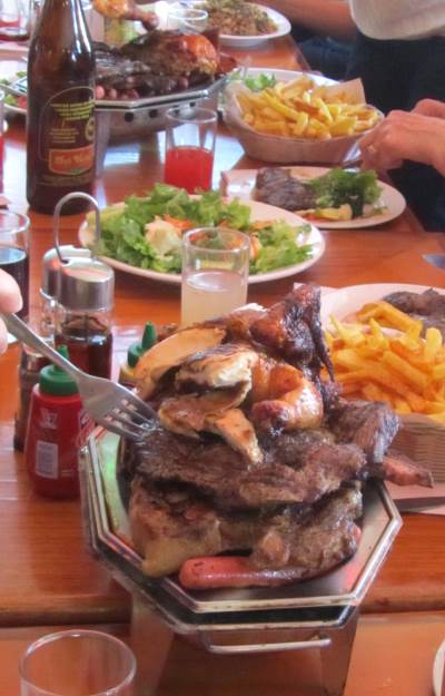 Barbecue meat and other food on a restaurant table