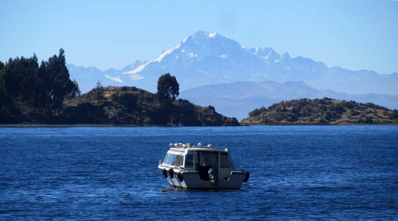 A boat on Lake Titicaca, with mountains in the background