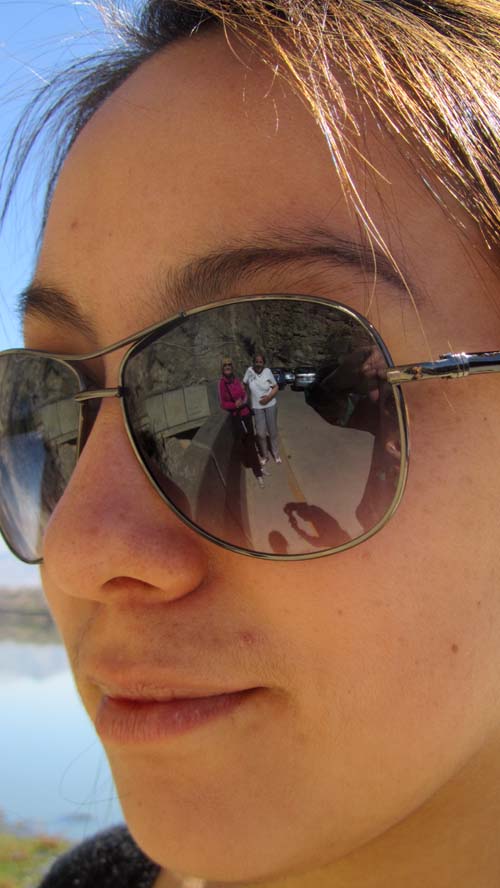 Miriam and another team member reflected in sunglasses