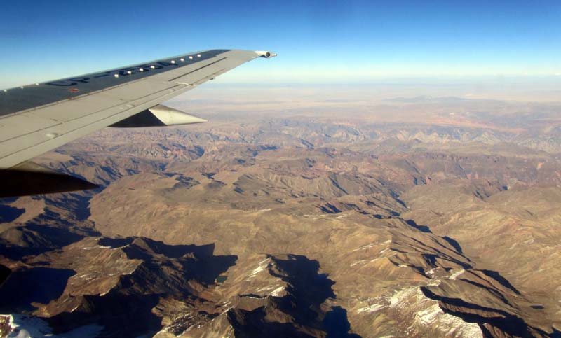 A barren, mountainous landscape viewed from a plane