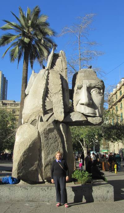 A statue of an indigenous man with a broken face