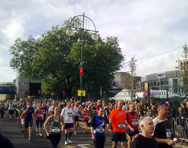 Runners walking along a sunlit street