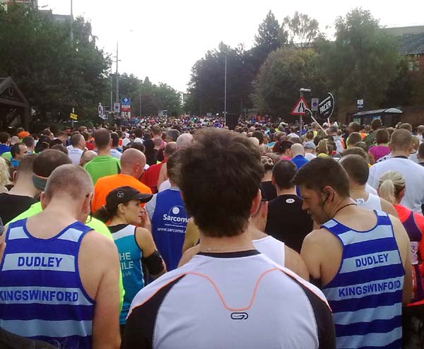 A crowd of runners in a city street