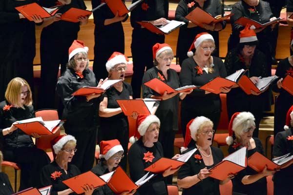 The choir wearing Santa hats