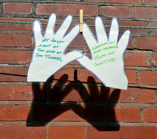 Paper cut-out hands on a line around Stirchley Baths