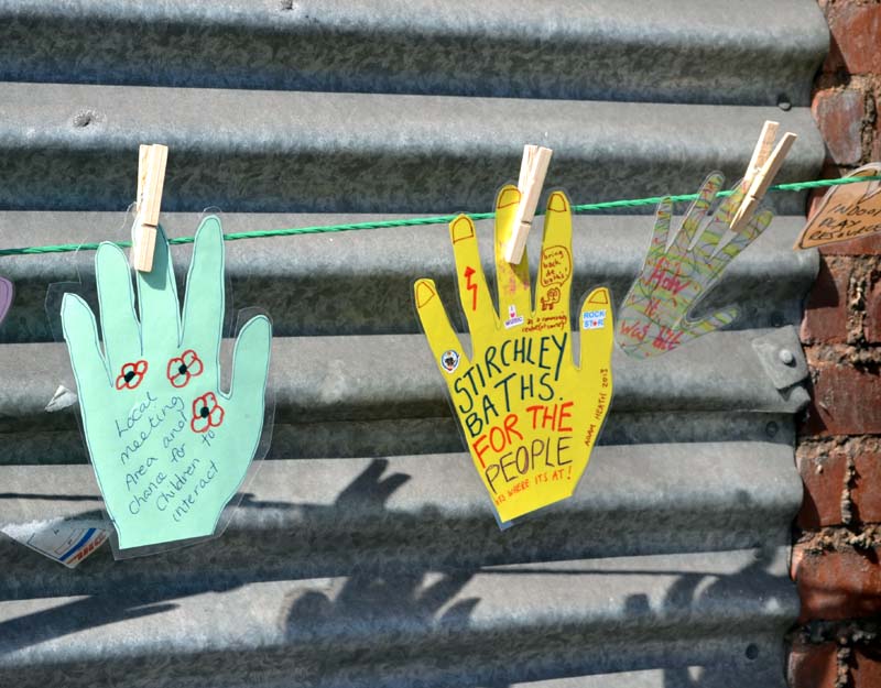 Paper cut-out hands on a line around Stirchley Baths