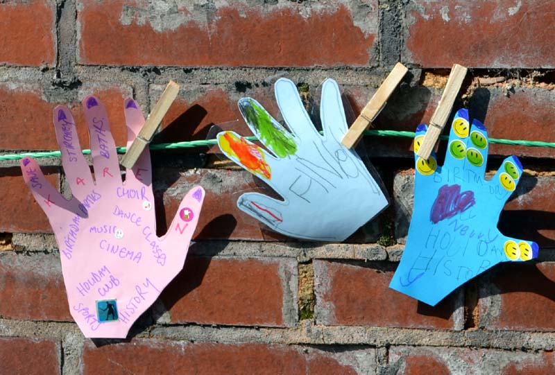 Paper cut-out hands on a line around Stirchley Baths