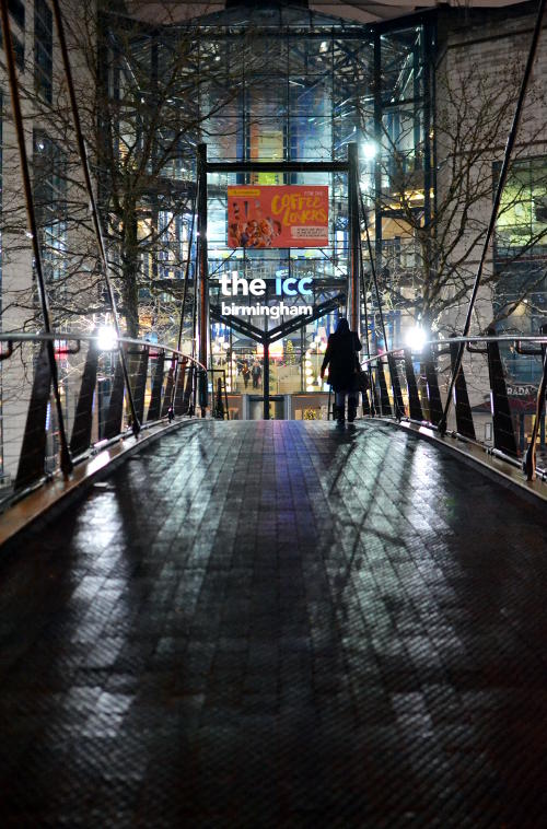 View of the ICC from across a footbridge at night