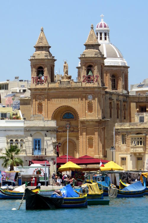 Traditional church building behind fishing boats