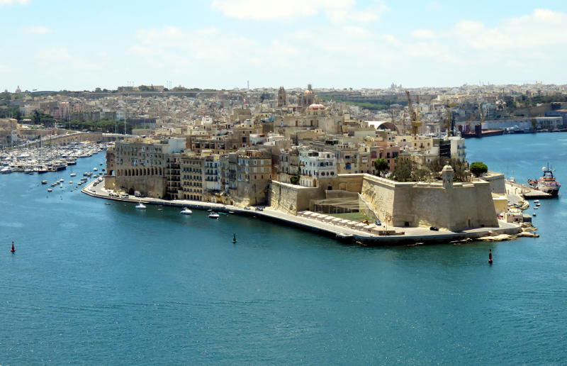 View across a harbour towards a built-up headland