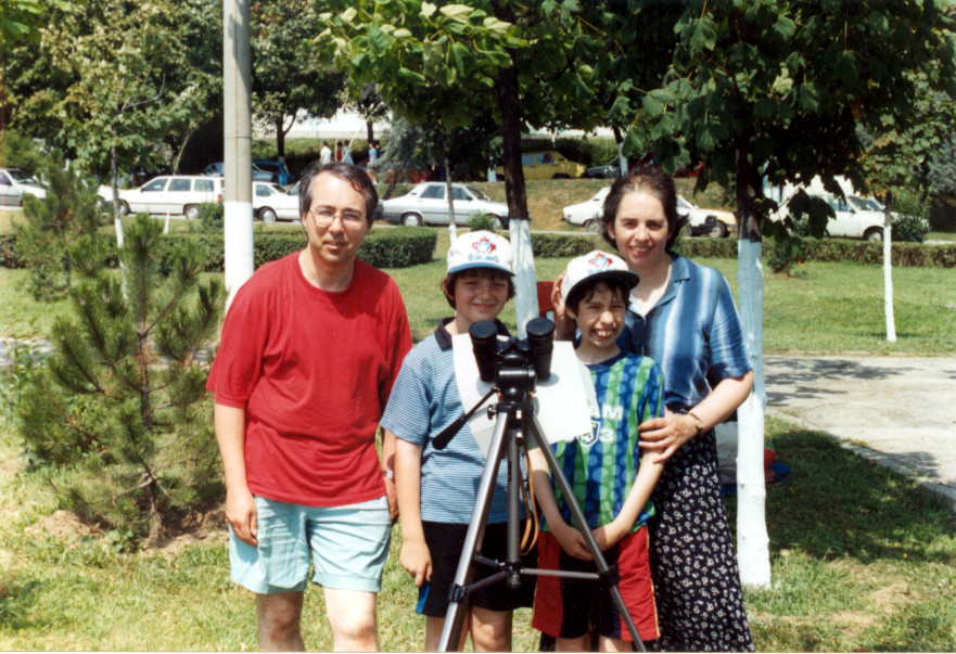 Our family standing behind binoculars mounted on a tripod