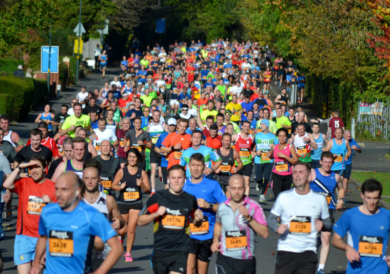 A crowd of runners coming down Selly Park Road