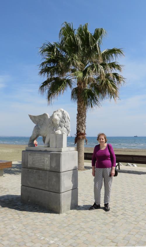 Miriam standing next to a statue by the seafront at Larnaca