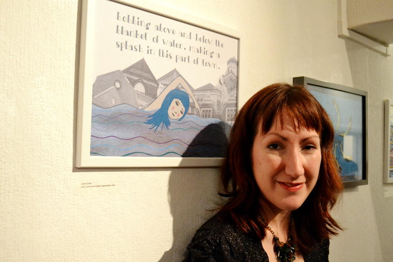 Carla Smith standing in front of her swimming-themed artwork