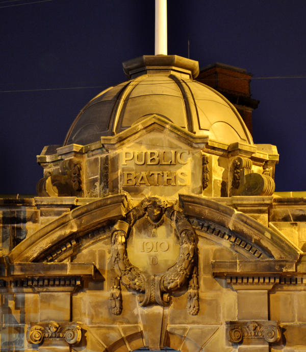 A stone cupola at night under street lighting