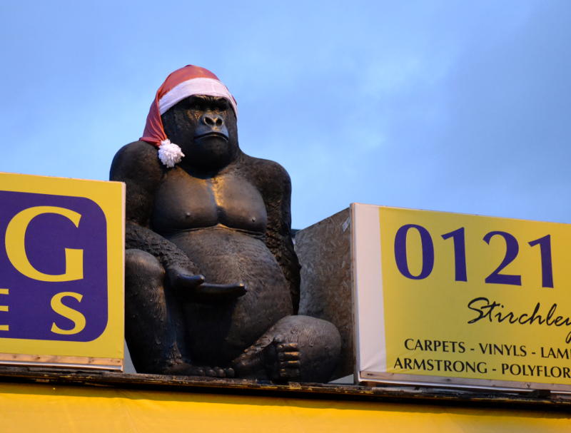 A King Kong model wearing a Santa hat