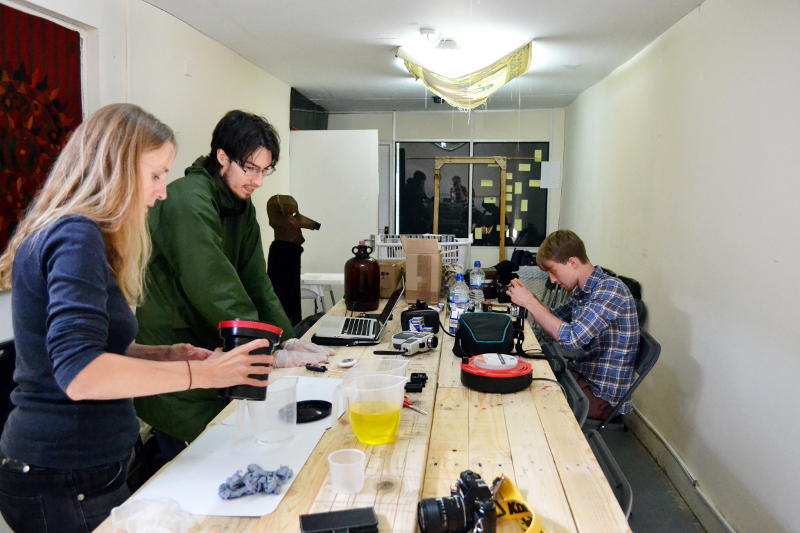 Martin developing black and white film with photographers Sarah and Ollie in the workshop at P Café