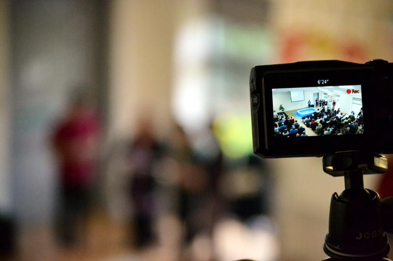 A baptism, with the camera focused on the display screen of another camera