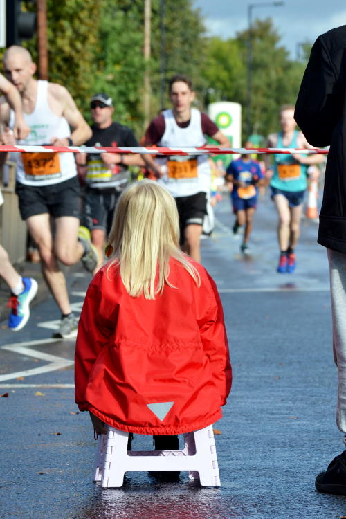 Seated spectator watching runners in the Great Birmingham Run 2016