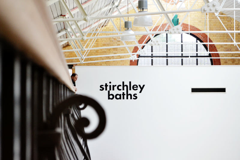 Looking along the outside of the balcony towards the Stirchley Baths logo