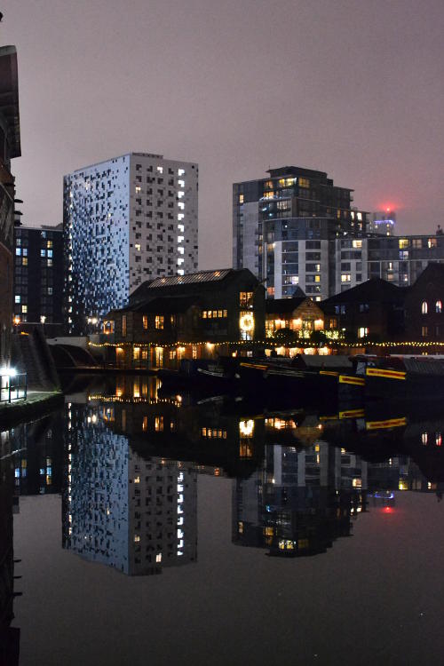 Gas Street Basin, with surrounding buildings reflected in the water, at night