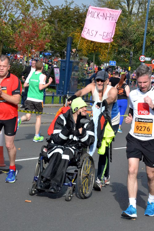 A runner pushing a friend in a wheelchair