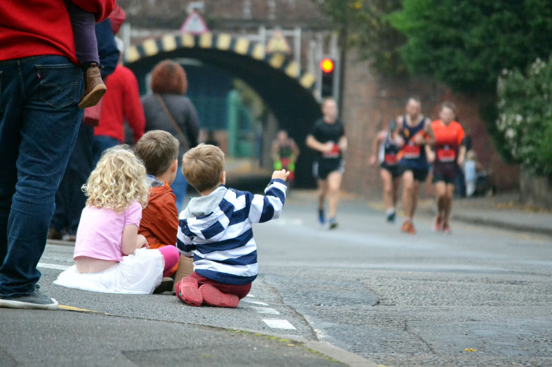 Youthful spectators sitting on the pavement