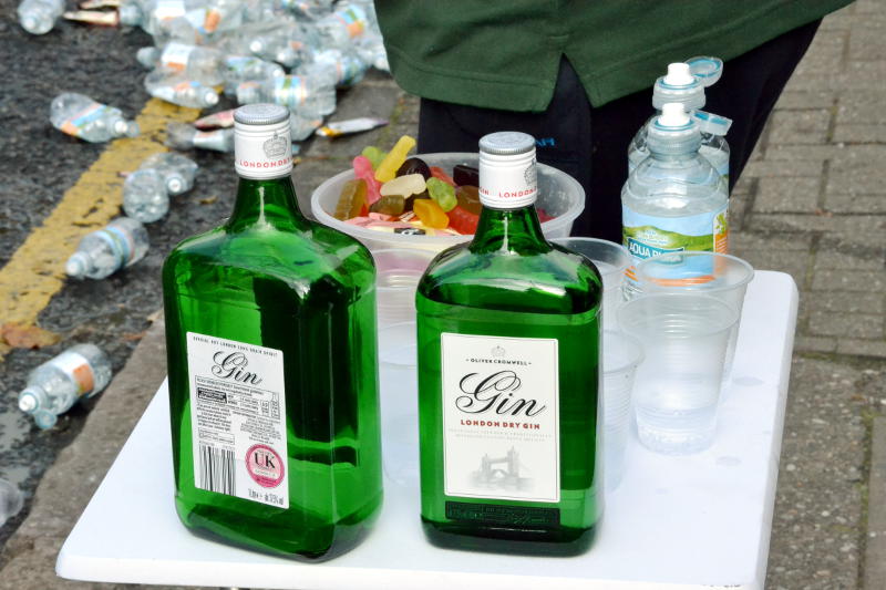 Gin bottles on a table by the roadside