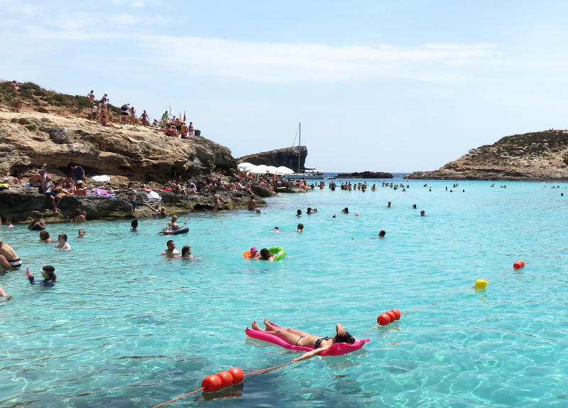 The crowds pack around the Blue Lagoon on Comino island