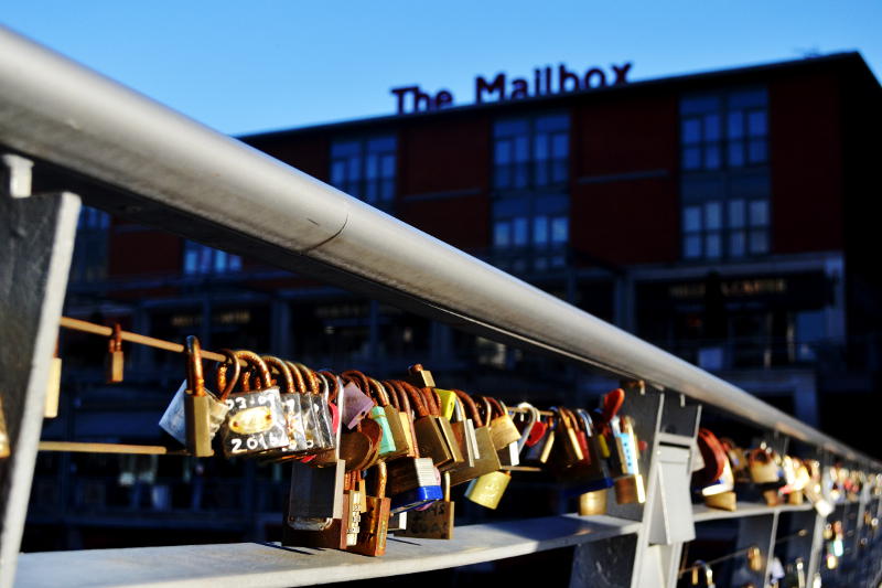 Padlocks attached to metal railings on the bridge