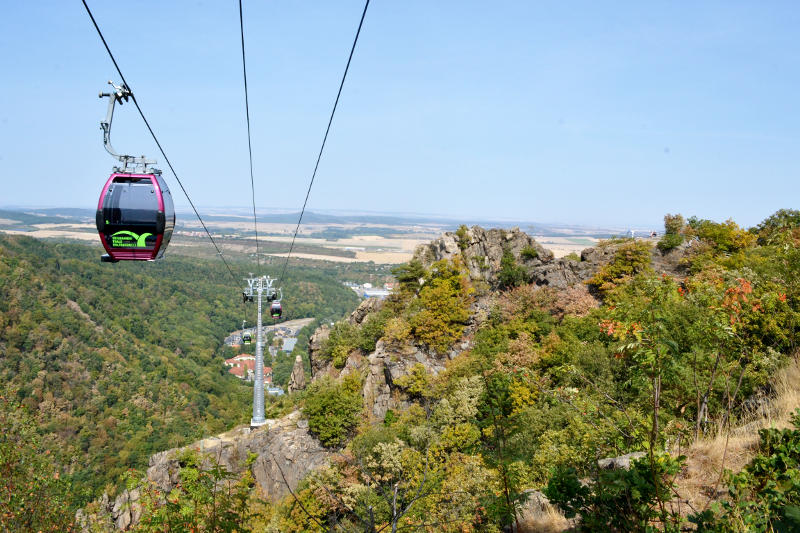 A cable car with a valley in the background