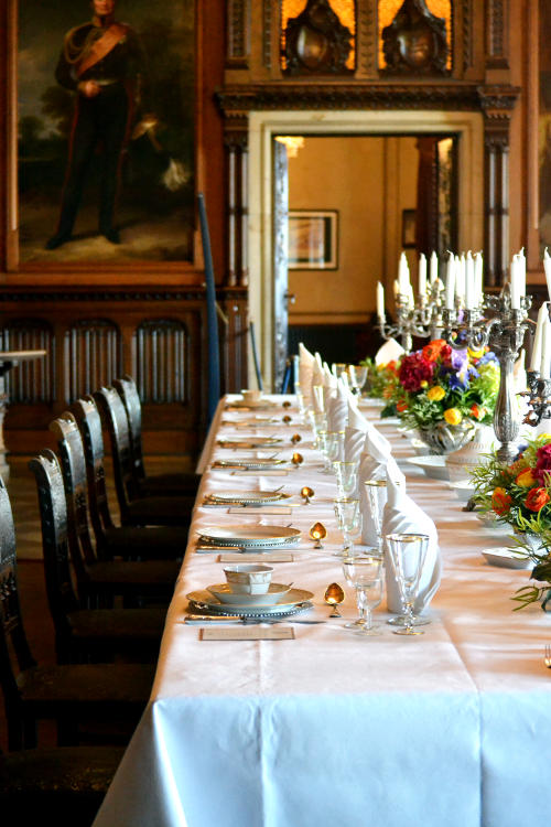 A dining hall with a full dinner service