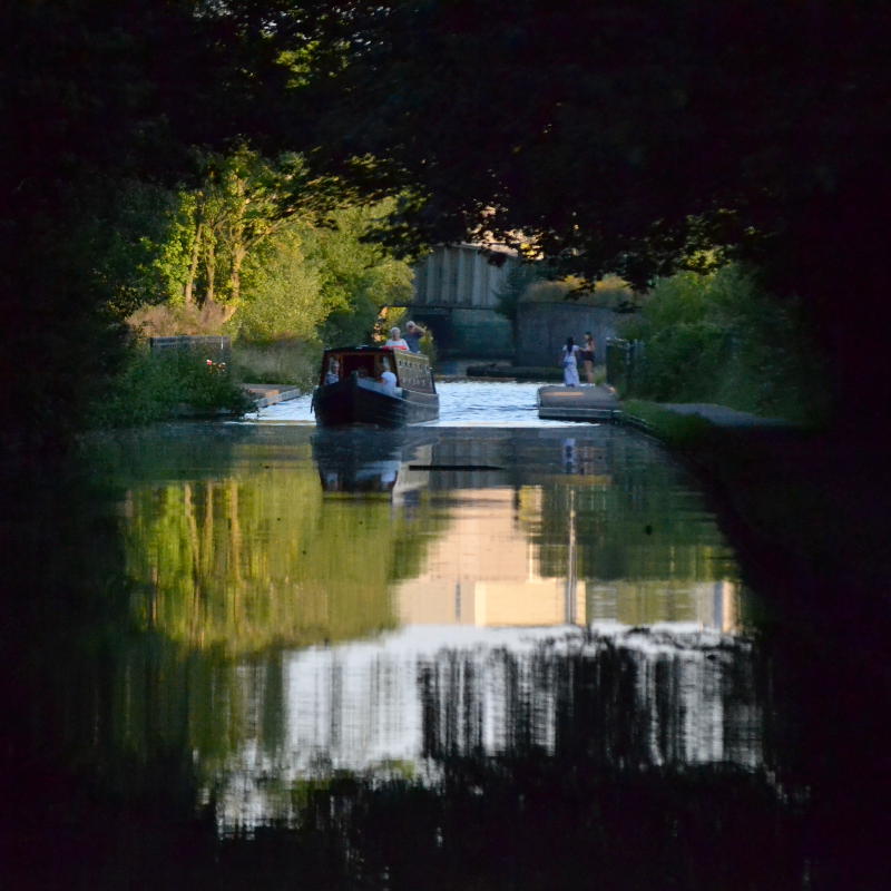 Looking back to Selly Oak aqueduct through a canopy of trees which line the banks of the canal