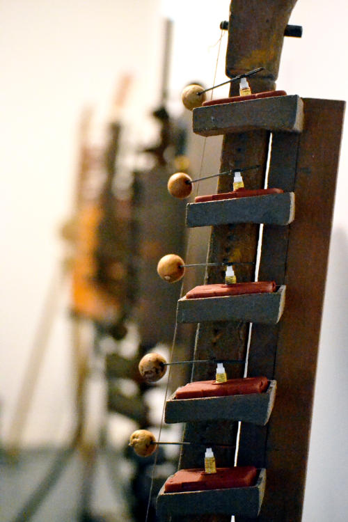 A stringed instrument with motors to hit hammers against the strings