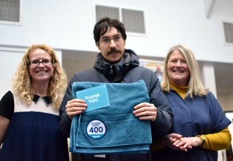 Martin presented with a towel commemorating 400 hours of volunteer time