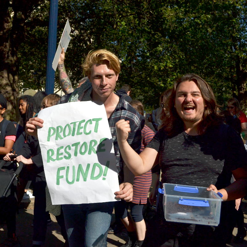 Stirchley arts duo Hipkiss and Graney marching with a placard