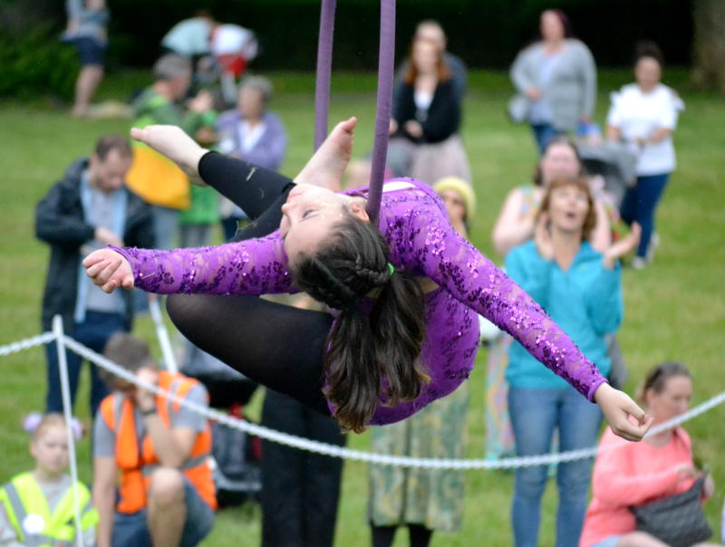 Acrobat hanging from a wire