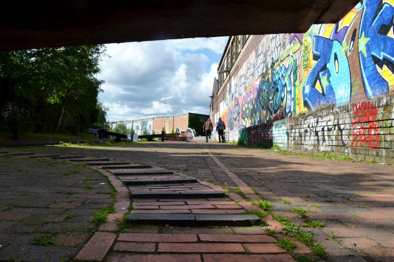 View of buildings from under a canal lock gate