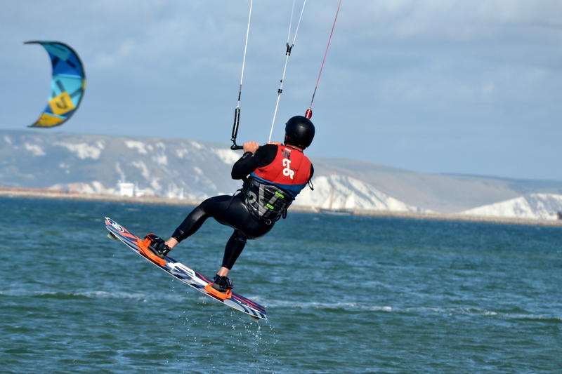 Kitesurfer taking off from the sea