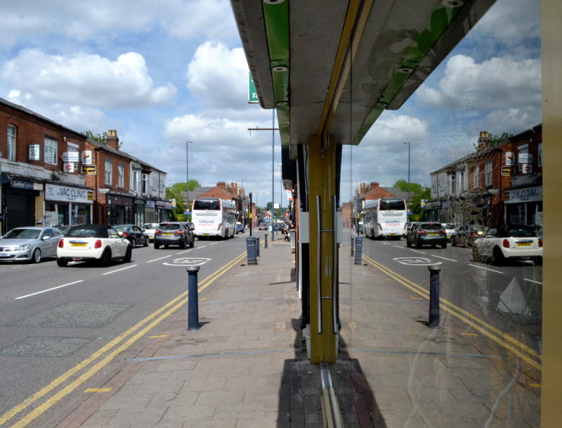 Reflection of Pershore Road in a glass window