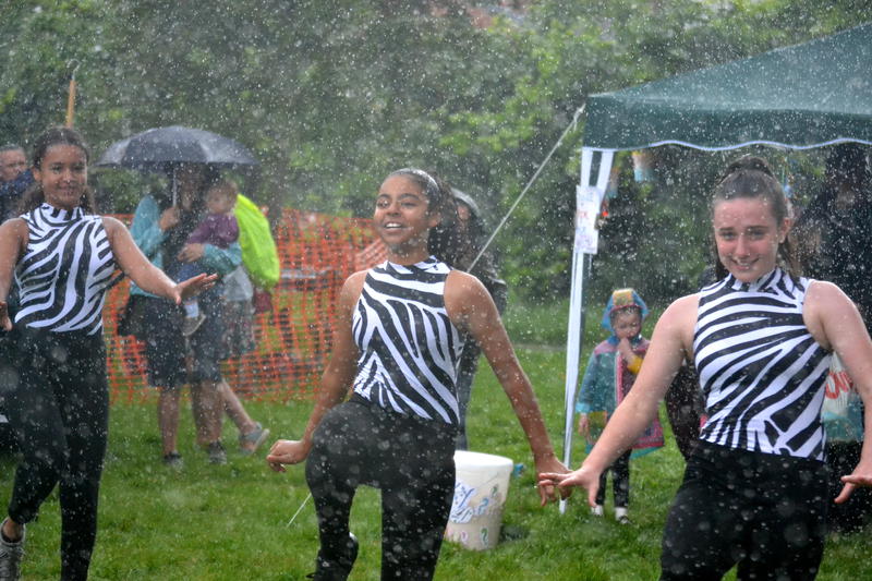 A group dancing in the rain