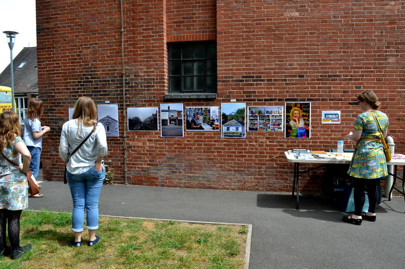 Photos on display along a wall