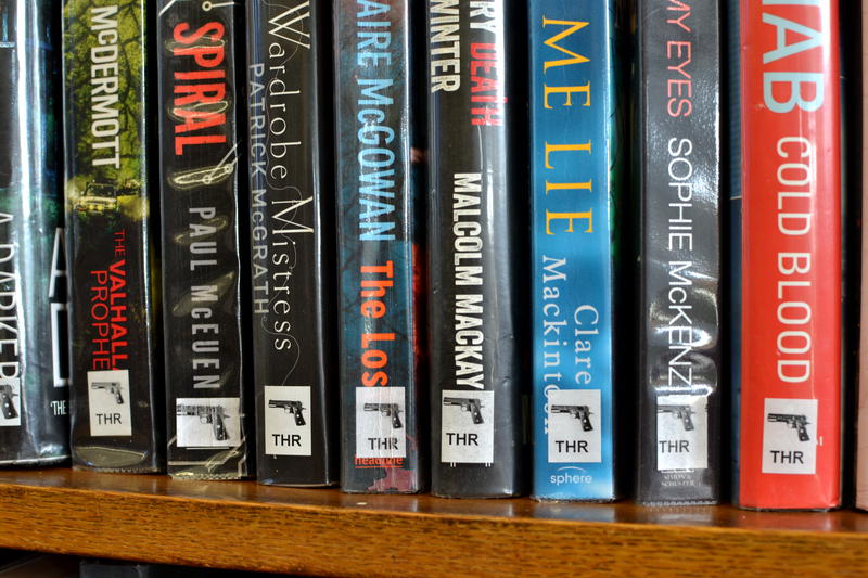 A row of thrillers on a library shelf